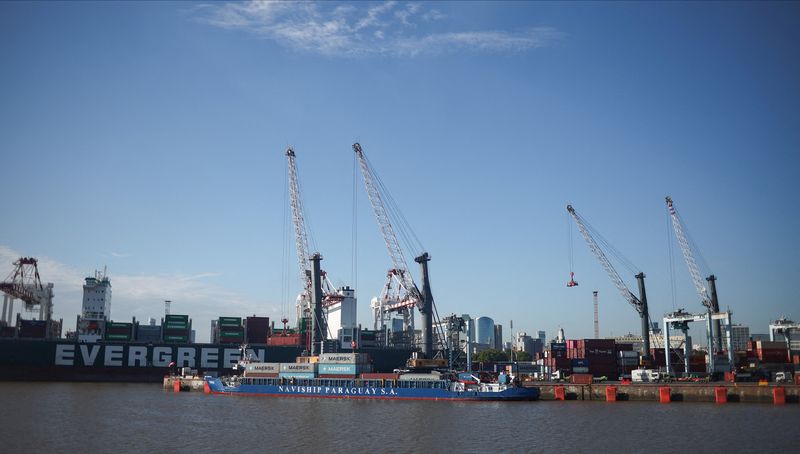 A cargo vessel moored in front of container cranes and Evergreen and Maersk branded containers, at the port of Buenos Aires, Argentina, January 15, 2026. REUTERS/Agustin Marcarian