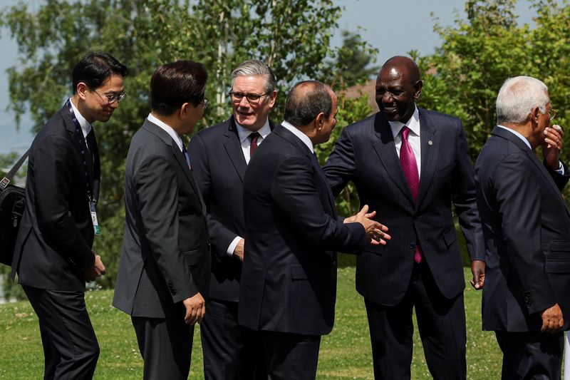 British Prime Minister Keir Starmer, South Korea's President Lee Jae Myung, Kenya's President William Ruto and Egyptian President Abdel Fattah al-Sisi, interact after posing for a family photo during the G7 summit, in Evian-les-Bains, France, June 16, 2026. REUTERS/Isabel Infantes/Pool