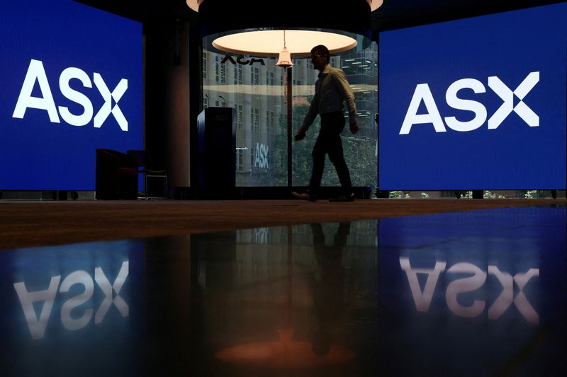 A man walks near displays of the ASX logo at the Australian Securities Exchange in Sydney, Australia, April 22, 2026. REUTERS/Hollie Adams      TPX IMAGES OF THE DAY