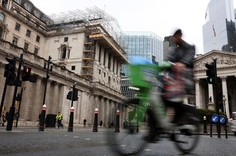 FILE PHOTO: A cyclist rides past the Bank of England building in London, Britain, May 19, 2026. REUTERS/Corey Rudy/File Photo