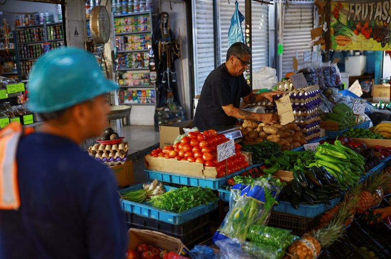 A worker sells fruits and vegetables at a market in Ciudad Juarez, Mexico, April 15, 2026. REUTERS/Jose Luis Gonzalez