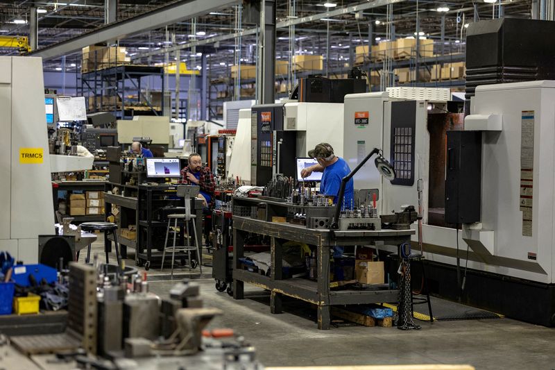 FILE PHOTO: Employees work on the production floor of the General Stamping & Metalworks building in South Bend, Indiana, U.S., March 23, 2026. REUTERS/Jim Vondruska/File Photo
