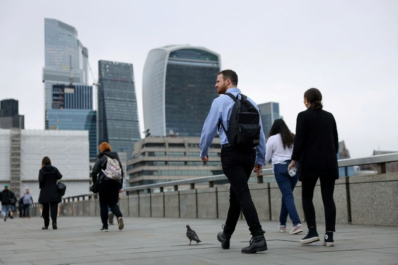 Commuters cross London Bridge in view of the City of London skyline in London, Britain, July 25, 2024. REUTERS/Hollie Adams