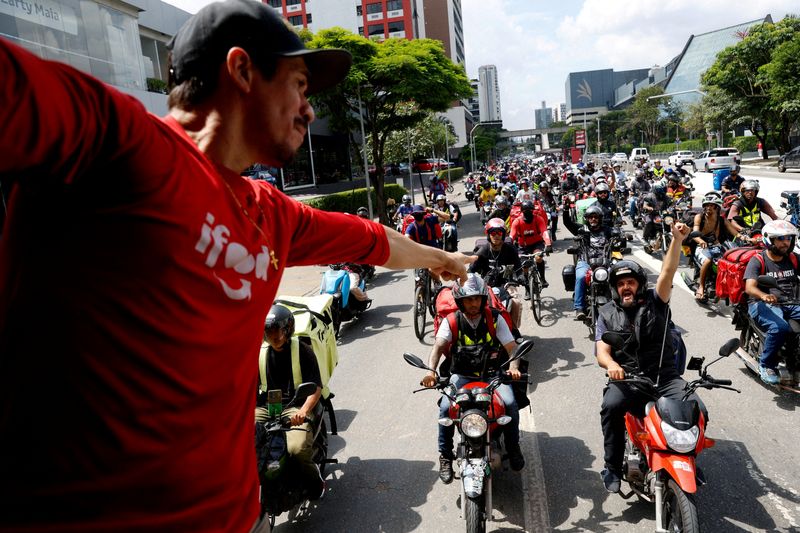FILE PHOTO: App delivery drivers working with iFood, Uber Eats, Rappi and other delivery apps take part in a protest to demand better pay and working conditions in Sao Paulo, Brazil March 31, 2025. REUTERS/Tuane Fernandes/File Photo