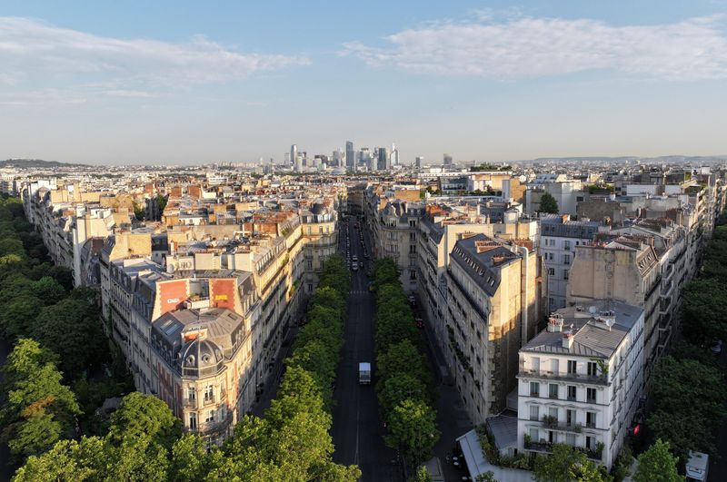A drone view shows the Paris skyline with rooftops of residential apartment buildings, and the financial and business district of La Defense in the background, in Paris, France, June 19, 2026. REUTERS/Lucien Libert