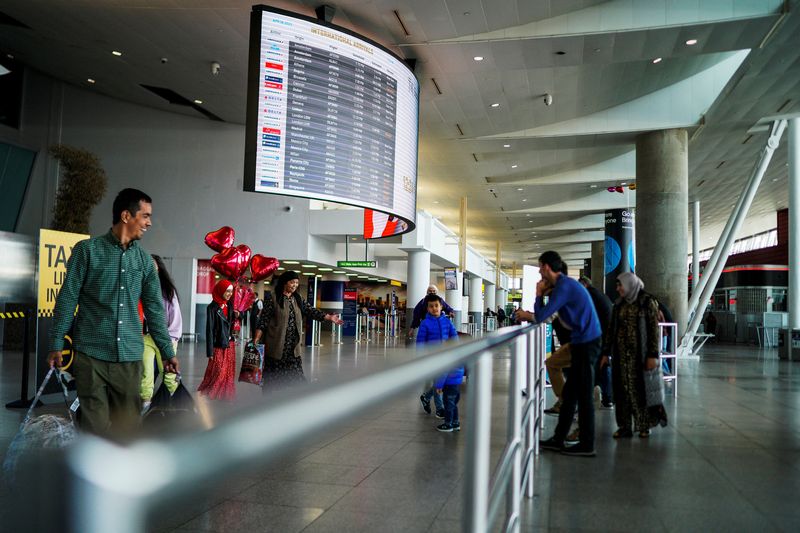 Travelers arrive at John F. Kennedy International Airport in New York City, U.S., April 6, 2023. REUTERS/Eduardo Munoz