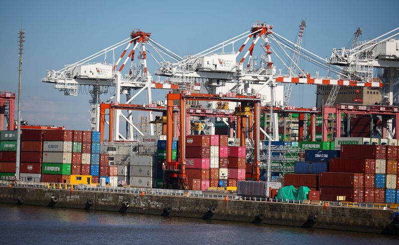 Stacks of shipping containers beneath container cranes at the port of Buenos Aires, Argentina, January 15, 2026. REUTERS/Agustin Marcarian