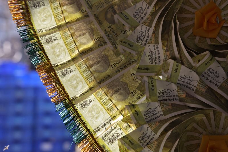 A garland made of Indian currency notes is displayed at a money exchange counter in the old quarters of Delhi, India, September 25, 2025. REUTERS/Bhawika Chhabra