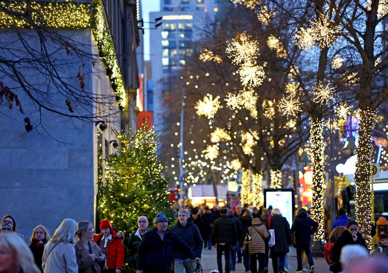People walk outside the department store Kaufhaus des Westens "KaDeWe" during Christmas season in Berlin, Germany, December 11, 2025. REUTERS/Lisi Niesner