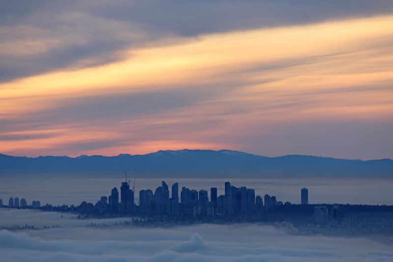 The skyline of the Metrotown district rises above a thick layer of fog at dawn as a ridge of high pressure creates a coastal temperature inversion in the Greater Vancouver city of Burnaby, British Columbia, Canada January 20, 2026. REUTERS/Chris Helgren