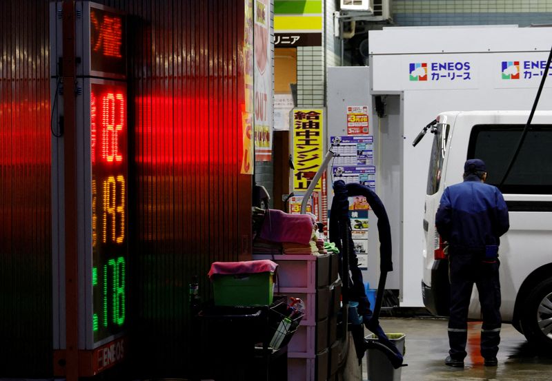 A staff fills up gas in a customer's car at a gasoline station in Tokyo, Japan, March 25, 2026. REUTERS/Kim Kyung-Hoon