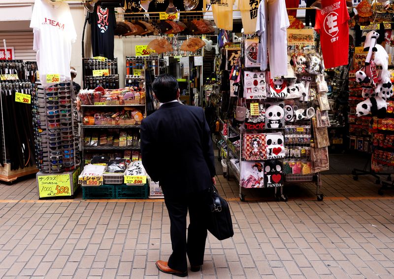 FILE PHOTO: A man looks at a shop at the Ameyoko shopping district in Tokyo, Japan, May 20, 2022. REUTERS/Kim Kyung-Hoon/ File Photo