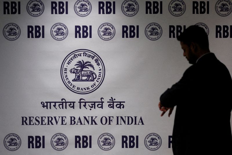 FILE PHOTO: A man stands in front of the Reserve Bank of India (RBI) logo inside its headquarters in Mumbai, India, February 6, 2026. REUTERS/Francis Mascarenhas/File Photo