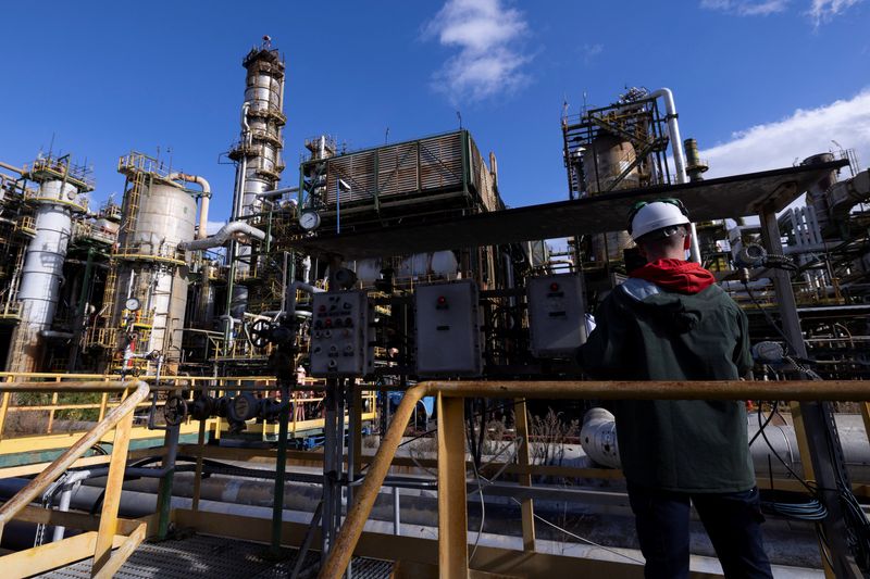 A worker operates machinery at an oil refinery in Cagliari, Italy, January 30, 2026. REUTERS/Remo Casilli/File Photo