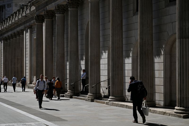 People walk by the Bank of England building in London, Britain, July 27, 2026. REUTERS/Chris J. Ratcliffe