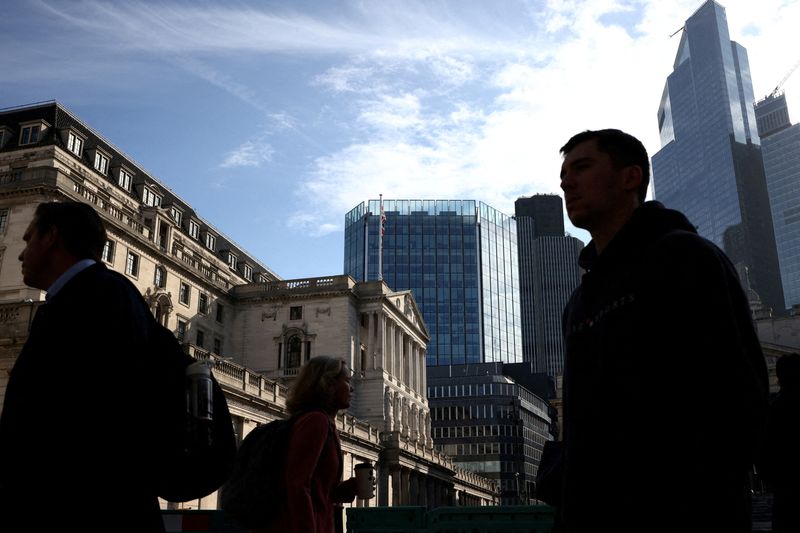 FILE PHOTO: People walk outside the Bank of England in the City of London financial district in London, Britain May 11, 2023. REUTERS/Henry Nicholls/File Photo