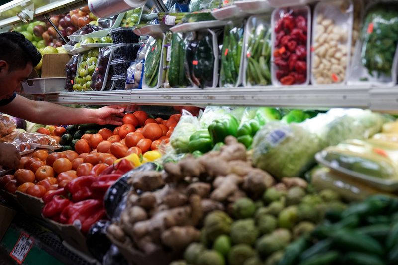 A person arranges groceries in El Progreso Market in the Mount Pleasant neighborhood of Washington, D.C., U.S., August 19, 2022. REUTERS/Sarah Silbiger