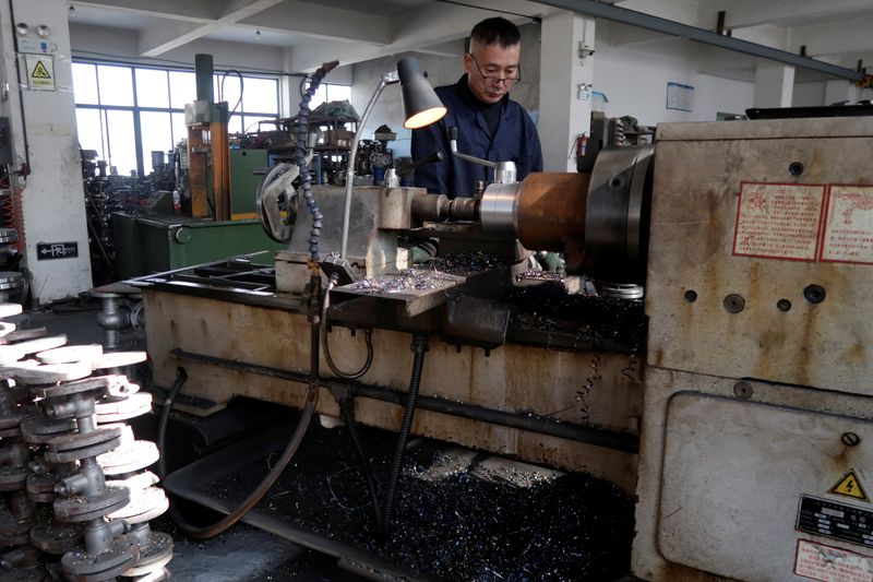 FILE PHOTO: An employee works on the production line manufacturing pipe-fitting valves at a factory in Wenzhou, Zhejiang province, China, January 14, 2026. REUTERS/Josh Arslan/File Photo