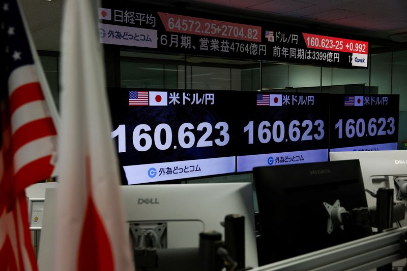 Monitors display the current Japanese Yen exchange rate against the U.S. dollar at a dealing room of the foreign exchange trading company Gaitame.com in Tokyo, Japan, July 31, 2026. REUTERS/Manami Yamada 