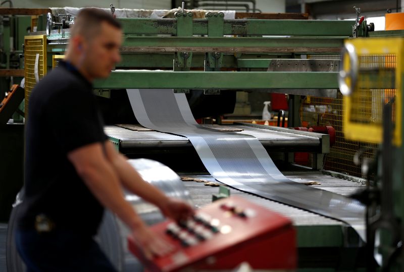 A worker at perforating company Bion uses a machine at the factory in Reading, Britain September 22, 2016. Picture taken September 22, 2016.   REUTERS/Peter Nicholls/Files