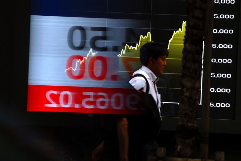 A person walks past a stock quotation board showing the Nikkei share average outside a brokerage in Tokyo, Japan, June 16, 2026. REUTERS/Manami Yamada
