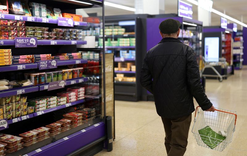 FILE PHOTO: A customer walks past a shelf inside a Sainsbury's supermarket, in Cobham, Britain, October 2, 2024. REUTERS/Mina Kim/File Photo