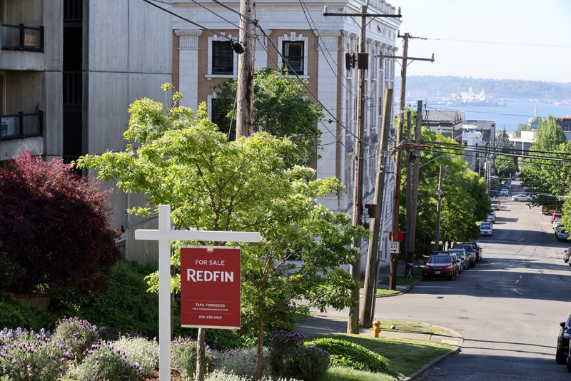 FILE PHOTO: A "For Sale" sign is posted outside a residential home in the Queen Anne neighborhood of Seattle, Washington, U.S. May 14, 2021. REUTERS/Karen Ducey/File Photo