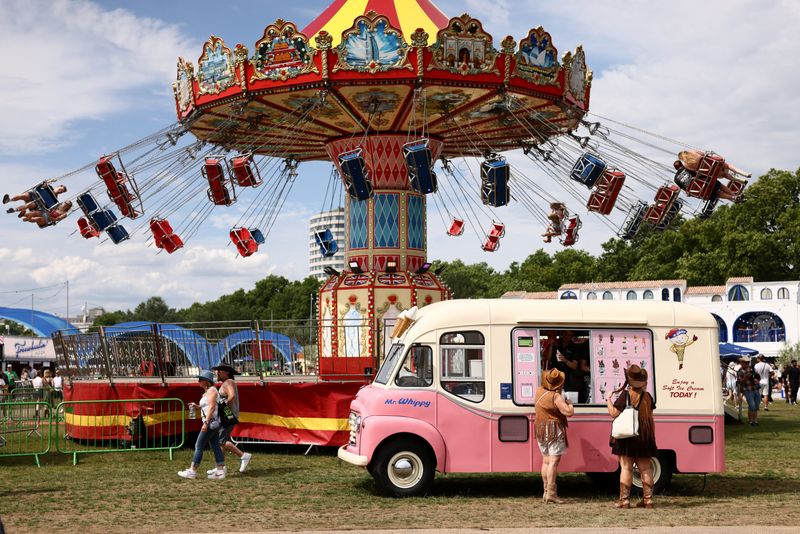 People wait to buy ice cream on the first day of BST Hyde Park in London, Britain, June 27, 2026. REUTERS/Jack Taylor/File Photo