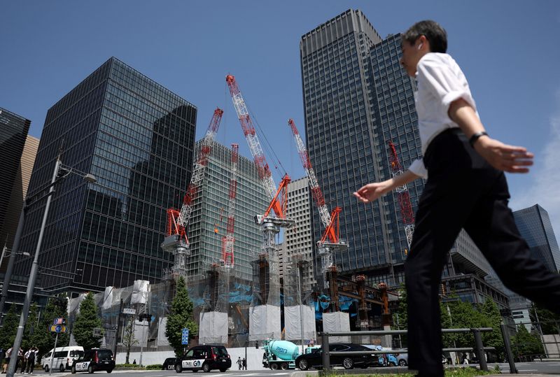 A man walks past on the street near a construction site in Tokyo, Japan May 19, 2026.  REUTERS/Issei Kato