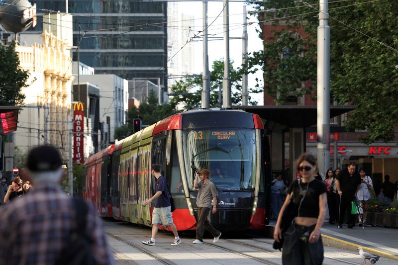 FILE PHOTO: Commuters cross the street at Town Hall, after Australia's unemployment rate reached 4.5%, in Sydney, Australia, October 16, 2025. REUTERS/Hollie Adams/File Photo