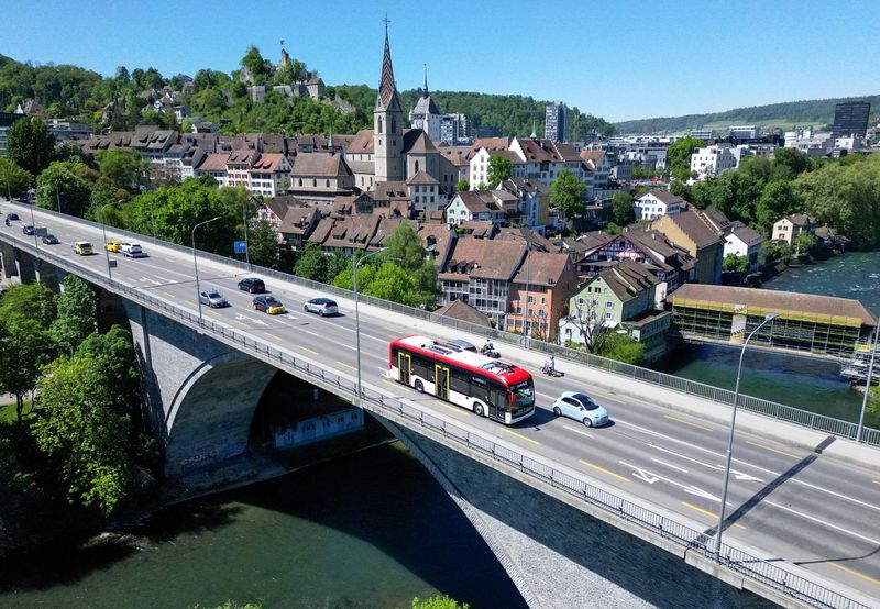FILE PHOTO: A drone view shows the "Line Zero" bus, an artistic experiment by Frank and Patrik Riklin designed to encourage social interaction and mindful travel by operating without a fixed route or destination, allowing passengers to board and leave freely as it moves through the Baden‑Wettingen area, near Zurich, arriving at its stop in Baden, Switzerland, April 30, 2026. REUTERS/Denis Balibouse/File Photo/File Photo