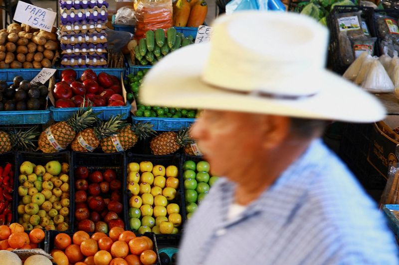 FILE PHOTO: A man walks past a market stall selling fruits and vegetables in Ciudad Juarez, Mexico, April 15, 2026. REUTERS/Jose Luis Gonzalez/File Photo