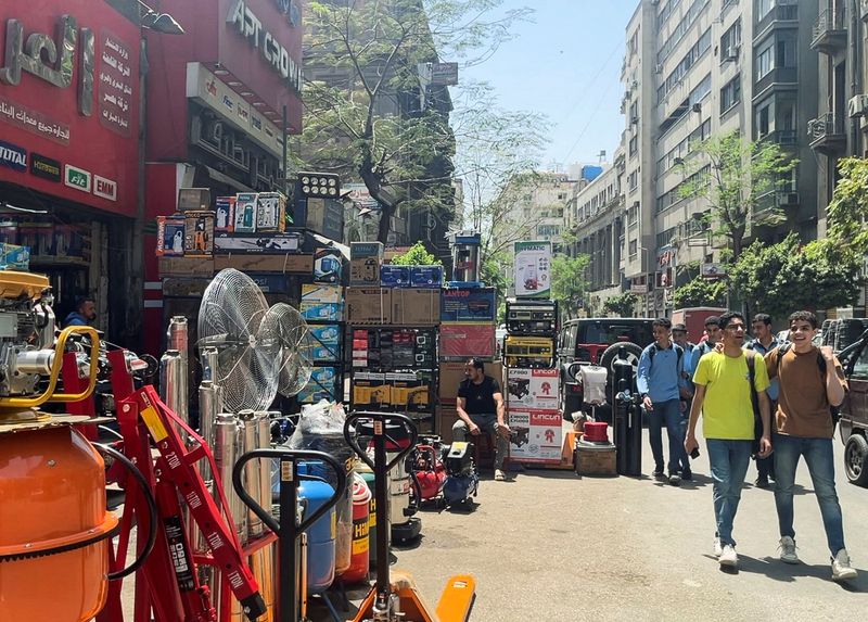 FILE PHOTO: People walk in front of "Al Araby", an Industrial electricity equipment shop in Cairo, Egypt May 2, 2024. REUTERS/Yazan Kalach/File Photo