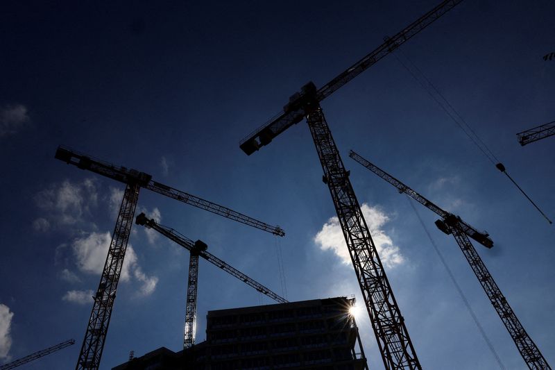 FILE PHOTO: A general view of cranes and a construction site silhouetted against the sun, ahead of the summit for affordable housing and construction at the Chancellery in Berlin, Germany September 25, 2023. REUTERS/Lisi Niesner/File Photo