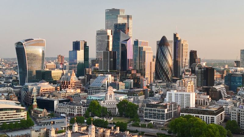 FILE PHOTO: A drone view of the City of London, Britain's financial powerhouse, at daybreak, as markets awaited a key interest rate decision by the Bank of England, in London, Britain June 19, 2025. REUTERS/Yann Tessier/File Photo