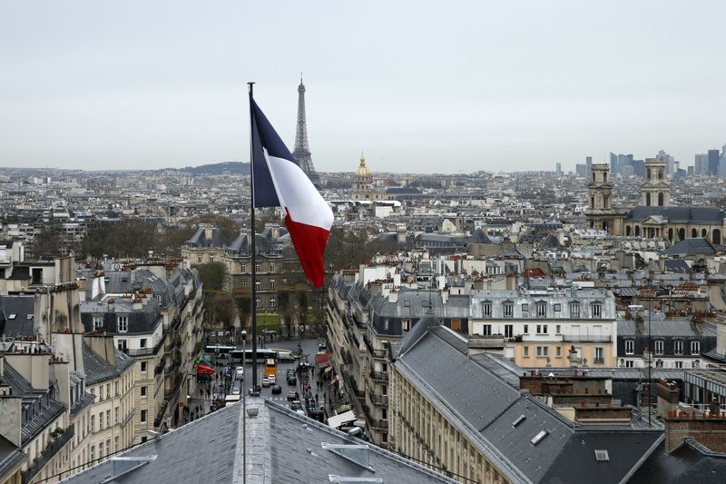 FILE PHOTO: A city view shows the French flag above the skyline of the French capital as the Eiffel Tower and roof tops are seen in Paris, France, March 30, 2016. REUTERS/Benoit Tessier/File Photo