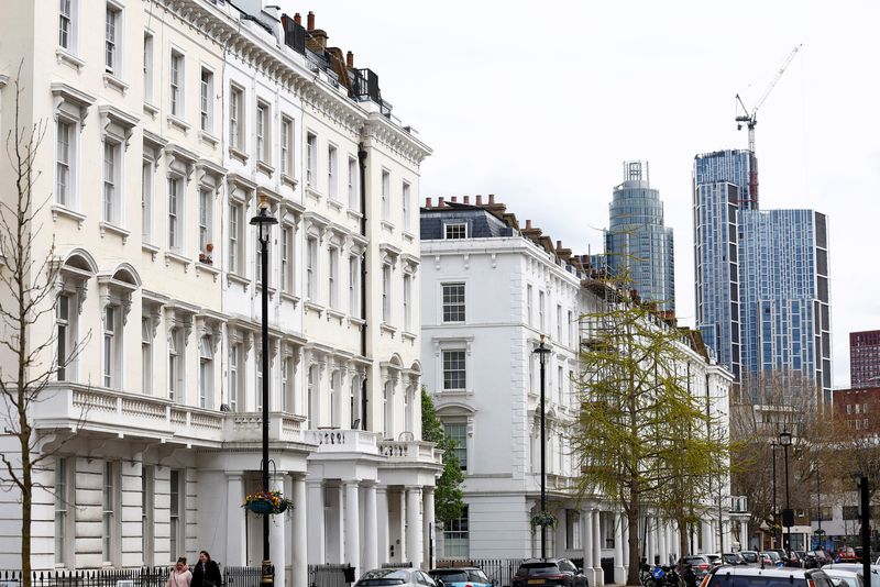 FILE PHOTO: New apartment blocks are seen behind traditional housing in London, Britain, April 16 2023.  REUTERS/Peter Nicholls/File Photo