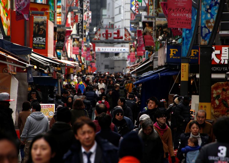 FILE PHOTO: People are seen at a market street in Tokyo, Japan, January 23, 2017. REUTERS/Kim Kyung-Hoon/File Photo