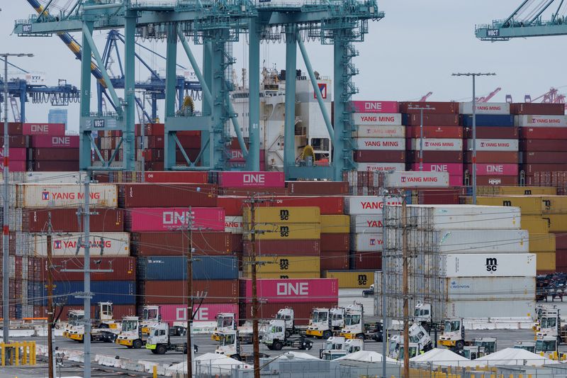 FILE PHOTO: A container ship is unloaded at the Port of Los Angeles, in San Pedro, California, U.S., May 1, 2025. REUTERS/Mike Blake/File Photo