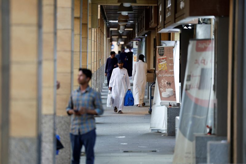 A man walks with shopping bags in a local souq down town Riyadh, Saudi Arabia, May 31, 2025. REUTERS/Hamad I Mohammed