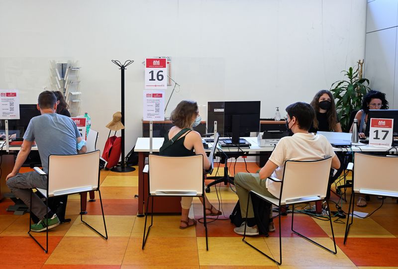 People are seen at an employment centre in Milan, Italy June 14, 2022. Picture taken June 14, 2022. REUTERS/Flavio Lo Scalzo