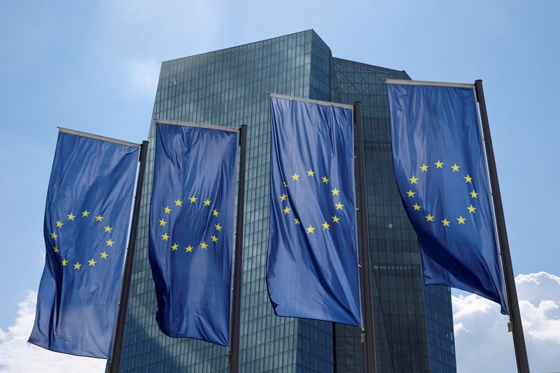 FILE PHOTO: European flags are seen in front of the European Central Bank (ECB) building, in Frankfurt, Germany, July 21, 2022. REUTERS/Wolfgang Rattay/File Photo