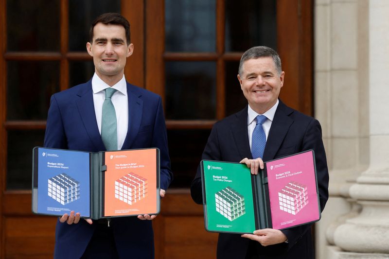 Ireland's Minister for Public Expenditure, Infrastructure, Public Service Reform and Digitalisation Jack Chambers and Minister for Finance Paschal Donohoe present the Budget 2026 documents in the courtyard of the Government Buildings, in Dublin, Ireland, October 7, 2025. REUTERS/Clodagh Kilcoyne