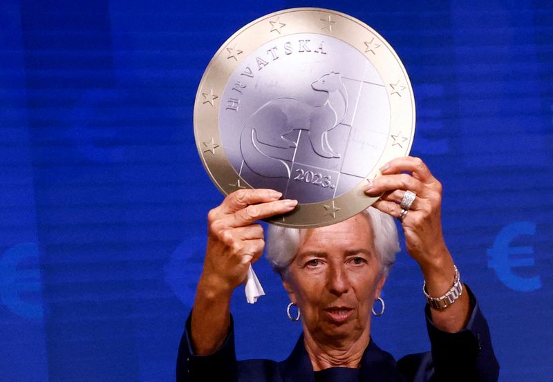 FILE PHOTO: President of European Central Bank Christine Lagarde poses with a model of a Euro coin after a signing ceremony on the adoption of the euro by Croatia in Brussels, Belgium July 12, 2022. REUTERS/Yves Herman//File Photo
