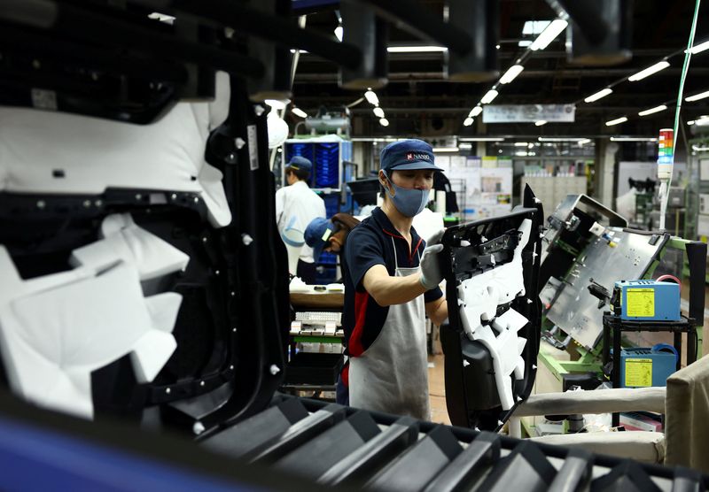 Employees work on the assembly line at Nanjo Auto Interior, a manufacturer of inside door panels and other parts for Mazda Motor, in Akitakata, Hiroshima Prefecture, Japan July 14, 2025.  REUTERS/Issei Kato