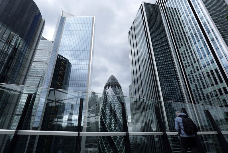 FILE PHOTO: A visitor looks out from the viewing area of Garden at 120 with commercial skyscrapers including The Gherkin seen behind, in the City of London financial district, in London, Britain, September 23, 2025. REUTERS/Toby Melville/File Photo