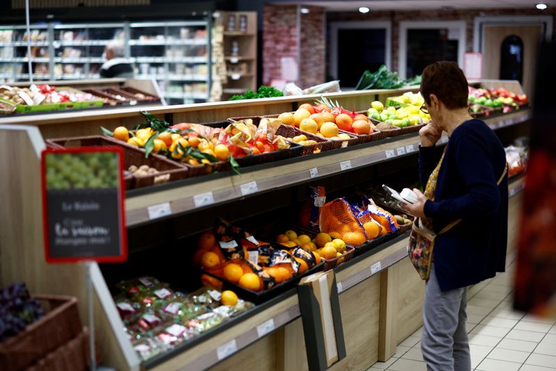 A woman shops in the fruit and vegetable section in a supermarket in Chanverrie, France, October 16, 2024. REUTERS/Stephane Mahe