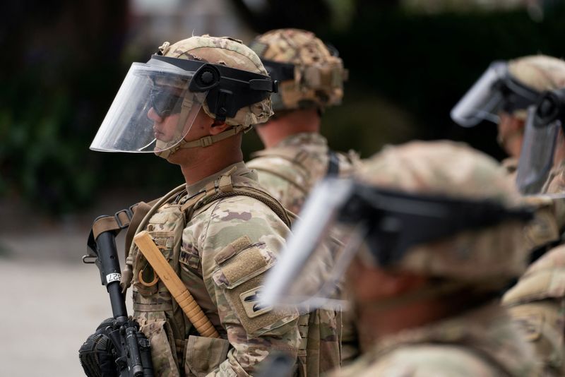 California National Guard personnel stand outside the Edward R. Roybal federal building after their deployment by U.S. President Donald Trump, in response to protests against immigration sweeps, in Los Angeles, California, U.S. June 8, 2025. REUTERS/David Ryder