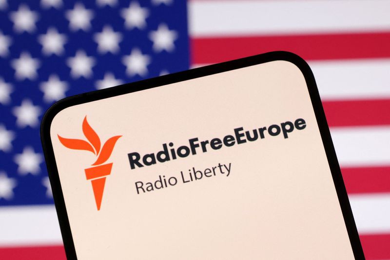 FILE PHOTO: Radio Free Europe logo and U.S. flag are seen in this illustration taken April 23, 2025. REUTERS/Dado Ruvic/Illustration/ File Photo