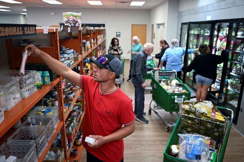 People select food at the Community Table food pantry, weeks into the continuing U.S. government shutdown, in Arvada, Colorado, U.S. October 22, 2025.  REUTERS/Mark Makela
